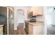 Bright kitchen with stainless steel appliances, wooden cabinets and a view into the home at 1411 E Orangewood Ave # 123, Phoenix, AZ 85020