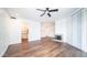 Well-lit living room featuring wood-look flooring, a fireplace, and an open layout at 1411 E Orangewood Ave # 123, Phoenix, AZ 85020