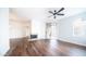 Bright and airy living room featuring a ceiling fan, fireplace, and access to a patio at 1411 E Orangewood Ave # 123, Phoenix, AZ 85020