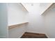 Walk-in closet with wood floors and wooden clothes racks and shelf at 1411 E Orangewood Ave # 123, Phoenix, AZ 85020