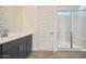 Bathroom featuring single vanity sink, framed mirror and walk-in shower with clear glass doors at 15005 W Gray Fox Trl, Surprise, AZ 85387