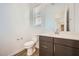 Half-bath featuring modern vanity, mirror, toilet, and wood-look tile flooring at 15005 W Gray Fox Trl, Surprise, AZ 85387