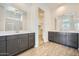 Bathroom featuring double sink vanity, framed mirrors, and walk-in shower with clear glass doors at 15005 W Gray Fox Trl, Surprise, AZ 85387