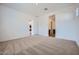 Spacious bedroom featuring neutral carpet, white walls, and doorway leading to other rooms at 15005 W Gray Fox Trl, Surprise, AZ 85387