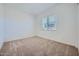 Bedroom featuring neutral carpet and window, creating a bright and well-lit space at 15005 W Gray Fox Trl, Surprise, AZ 85387