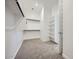 Walk-in closet featuring shelving, clothes rods, carpet flooring and plenty of storage space at 15005 W Gray Fox Trl, Surprise, AZ 85387