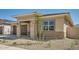 Cozy single-story home with a two-car garage, well-manicured landscaping, and a welcoming covered entry at 15005 W Gray Fox Trl, Surprise, AZ 85387