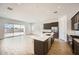 Gourmet kitchen featuring a large island, dark wood cabinets, stainless steel appliances, and tile flooring at 15005 W Gray Fox Trl, Surprise, AZ 85387