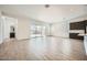 Bright and airy living room with tile floors, sliding glass doors, and dark cabinets with light countertops at 15005 W Gray Fox Trl, Surprise, AZ 85387