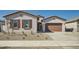 Charming single-story home featuring a well-manicured front yard and a two-car garage at 15036 W Smoketree Dr, Surprise, AZ 85387