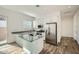 Modern kitchen with granite countertops, stainless steel appliances, an island with sink, and wood look tile flooring at 15036 W Smoketree Dr, Surprise, AZ 85387