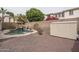 Landscaped backyard featuring a sparkling pool with waterfall and a storage shed at 15658 W Cortez St, Surprise, AZ 85379