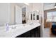 Double sink bathroom with white countertops and dark cabinetry, with mirrors above each sink at 15658 W Cortez St, Surprise, AZ 85379
