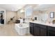 A spacious bathroom featuring a soaking tub, dual vanities, and a separate shower at 15658 W Cortez St, Surprise, AZ 85379