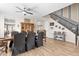 Elegant dining room with wood floors, ceiling fan, and staircase with iron balusters at 15658 W Cortez St, Surprise, AZ 85379