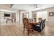 Inviting dining room featuring decorative chairs, wood floors, and adjacent living space at 15658 W Cortez St, Surprise, AZ 85379