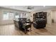 Relaxing living room with a comfortable leather sofa and large windows at 15658 W Cortez St, Surprise, AZ 85379