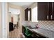 Office nook with built-in desk and cabinets, plus stylish backsplash at 15658 W Cortez St, Surprise, AZ 85379