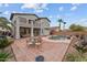 Outdoor dining and entertaining space featuring a pool, a patio, beautiful landscaping, and palm trees at 16533 W Carmen Dr, Surprise, AZ 85388
