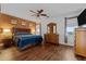 Cozy bedroom with a brick accent wall, wooden furniture, and warm lighting at 16533 W Carmen Dr, Surprise, AZ 85388