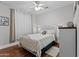 This bedroom features a cozy atmosphere with a white metal frame bed and hardwood floors at 16533 W Carmen Dr, Surprise, AZ 85388