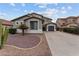 Charming two-story home featuring a three-car garage and desert landscaping in the front yard at 16533 W Carmen Dr, Surprise, AZ 85388