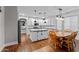 Open kitchen with white cabinets, a center island, and a dining table at 16533 W Carmen Dr, Surprise, AZ 85388