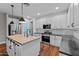 Stylish kitchen with white cabinets, stainless steel appliances, and a center island at 16533 W Carmen Dr, Surprise, AZ 85388