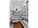 Pantry with wooden floors and filled white shelves offer storage for all your kitchen necessities at 16533 W Carmen Dr, Surprise, AZ 85388