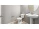 Powder bathroom featuring pedestal sink, decorative mirror, and neutral wall color at 16771 W Adams St, Goodyear, AZ 85338