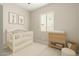 Cozy Bedroom with a white crib and changing table at 16771 W Adams St, Goodyear, AZ 85338