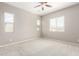 Bright bedroom with three windows, neutral walls, and plush carpet at 16771 W Adams St, Goodyear, AZ 85338