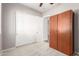 Bedroom features neutral carpet, a closet, wardrobe, and a ceiling fan at 16771 W Adams St, Goodyear, AZ 85338