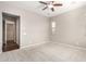 Spacious bedroom features neutral carpet, ceiling fan, and natural light from the window at 16771 W Adams St, Goodyear, AZ 85338