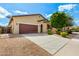 Well-manicured front yard and exterior view of a lovely single-Gathering home with a brown garage door at 16771 W Adams St, Goodyear, AZ 85338