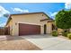 Charming home exterior with a spacious driveway and low-maintenance desert landscaping at 16771 W Adams St, Goodyear, AZ 85338
