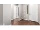 Bright foyer with hardwood flooring, white trim, and a modern front door at 16771 W Adams St, Goodyear, AZ 85338