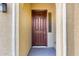 Inviting front door with a rich, dark finish and stylish archway, enhanced by a sidelight window at 16771 W Adams St, Goodyear, AZ 85338