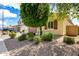 Manicured front yard featuring decorative rock landscaping and lush greenery enhancing the curb appeal at 16771 W Adams St, Goodyear, AZ 85338