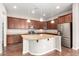 Modern kitchen featuring stainless steel appliances, granite countertops, and custom cabinets at 16771 W Adams St, Goodyear, AZ 85338