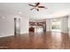 Spacious living area with hardwood floors and an open layout to the kitchen and dining area at 16771 W Adams St, Goodyear, AZ 85338