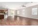 Open-concept living area with hardwood floors, natural light, and seamless kitchen access at 16771 W Adams St, Goodyear, AZ 85338