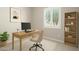 Comfortable home office features a large window and built-in bookshelves at 16771 W Adams St, Goodyear, AZ 85338