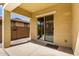 Covered patio featuring a sliding glass door and neutral concrete slab at 16771 W Adams St, Goodyear, AZ 85338