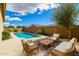 Inviting pool area with comfortable seating and a well-maintained yard at 16771 W Adams St, Goodyear, AZ 85338