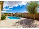 Backyard pool area surrounded by patio, landscaping, and block fence at 16771 W Adams St, Goodyear, AZ 85338