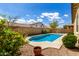 Pool with surrounding foliage and wall, nestled in a sunny backyard at 16771 W Adams St, Goodyear, AZ 85338