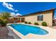 Inviting backyard pool with lush landscaping and stucco home exterior at 16771 W Adams St, Goodyear, AZ 85338