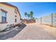 View of a backyard with rock landscaping, a swing set and desert plants at 17008 W Sonora St, Goodyear, AZ 85338