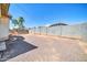 View of large backyard area featuring a retaining wall, swing set and landscaping with desert plants at 17008 W Sonora St, Goodyear, AZ 85338